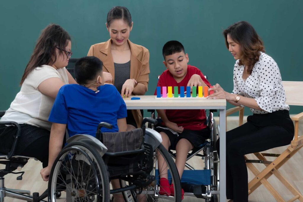 Teacher working with students with disabilities